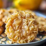 Glazed Lemon Oatmeal No-Bake Cookie with bright oats and golden sheen, served on a plate, featuring a zesty, chewy texture and uplifting citrus color.