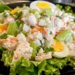 Colorful Classic Chicken Salad with tender chicken, crisp celery, eggs, parsley, and creamy dressing on fresh lettuce.