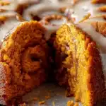 Close-up of moist sweet potato honeybun cake with cinnamon swirl and glaze drizzle