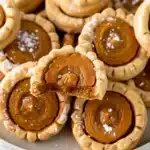 Close-up of delicious pumpkin pie cookies with creamy filling and whipped cream topping on a plate