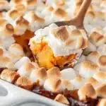 Close-up of sweet potato casserole topped with perfectly toasted mini marshmallows and pecans